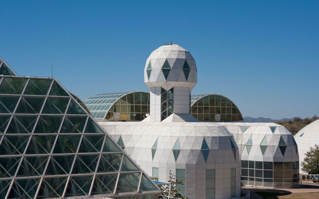 a white building with a large dome and glass panels