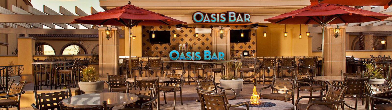 A bar with tables, chairs, and umbrellas